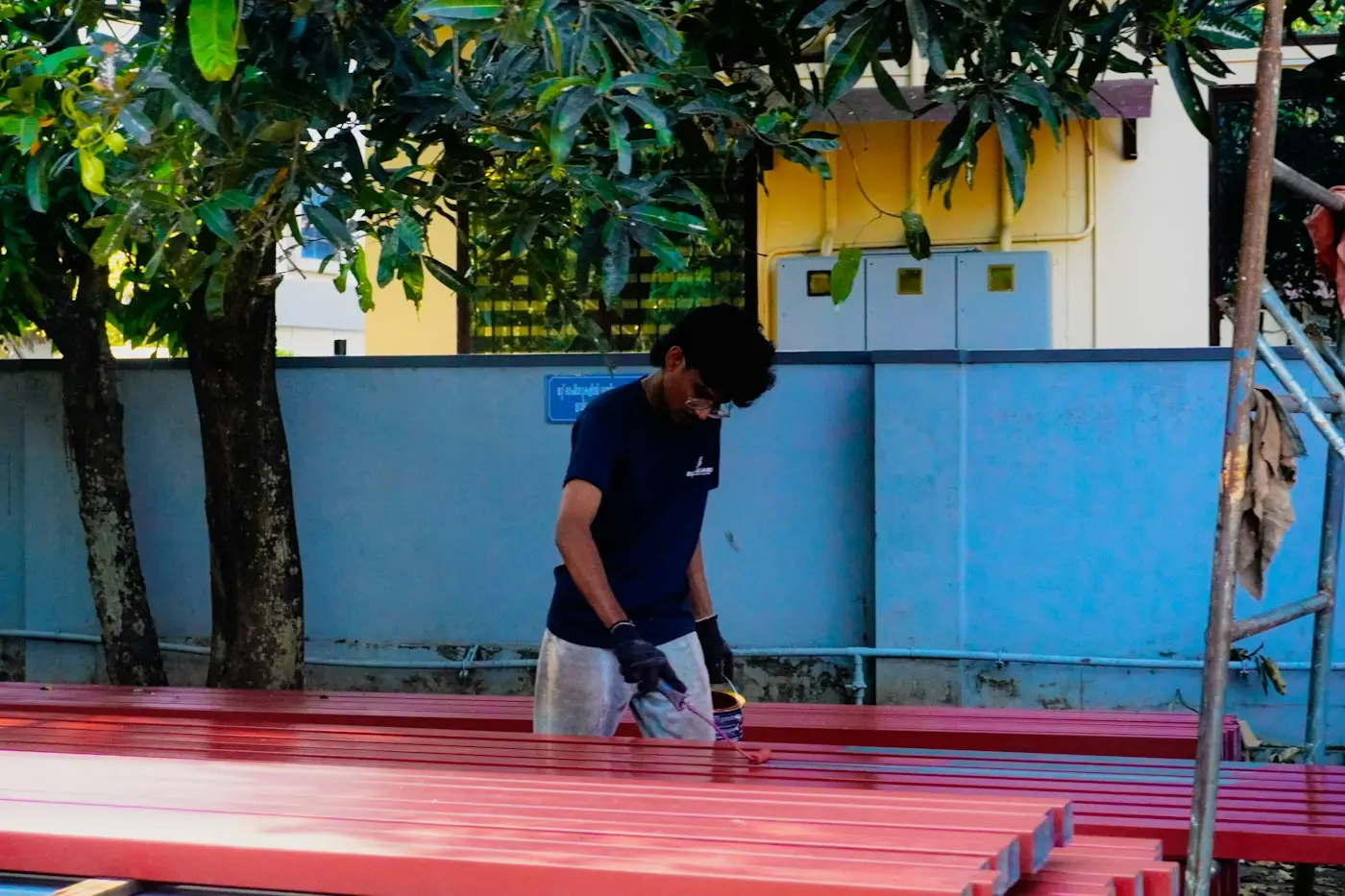 Pintor pintando con pincel unas rejas de hierro